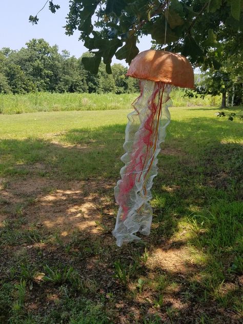 Paper mache jellyfish with ribbon and netting for tentacles Paper Mache Jellyfish, Rainforest Birthday, Jellyfish Hanging, Lantern Decorations, Upcycled Books, Paper Lantern Decor, Pirate Theme Party, Mermaid Diy, Upcycle Books