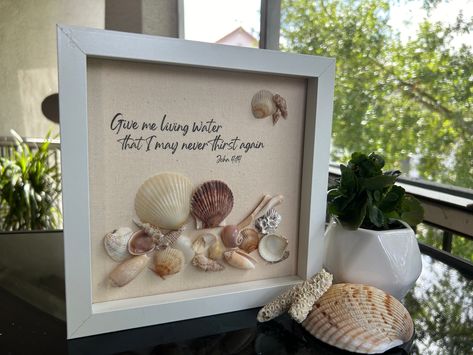 8 x 8 original, one-of-a-kind shell art in a glass-front shadow box. Seashells were ethically collected from Southwest Florida beaches, and thoroughly cleaned and organically polished. Text is printed on fabric for a natural look. *This piece features scallop shells in a variety of colors. It also has ceriths, olives, and a shark eye, amidst a few other treasures. Framed in a white frame, may this piece help quench your thirst! *Please note that I take my collected shells through a multi-step cleaning process... but you never know if a little sand is deep within certain shells. Consider finding a granule within the box a bonus feature as something may come out in shipping. Please also note that as these are authentic gulf shells, you will see natural variances -- no two shells are exactly Water Shadow, Beach Shadow Boxes, Seashell Shadow Boxes, Custom Shadow Box, Word Art Design, Shell Crafts Diy, Southwest Florida, Mdf Frame, Living Water