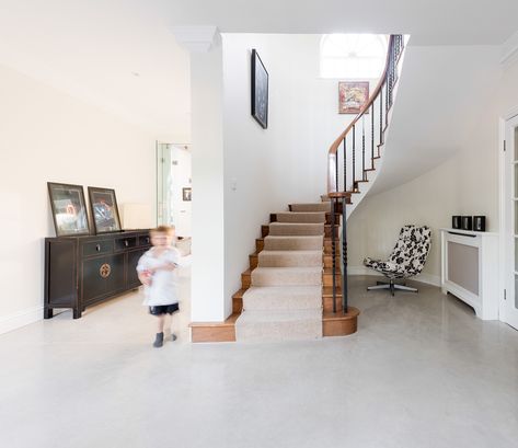 Polished concrete was chosen to cover the ground floor areas of this Surrey family home, from the entrance hall all the way through to the kitchen, boot room and utility room. The homeowners chose concrete flooring due to its architectural aesthetic, creating a unified and pleasing artistic statement; for its hard wearing qualities with children and pets and because it is easy to maintain. Concrete Entryway, Architectural Aesthetic, Polished Concrete Floor, Concrete Flooring, Concrete Floor, Boot Room, Polished Concrete, Utility Room, Underfloor Heating