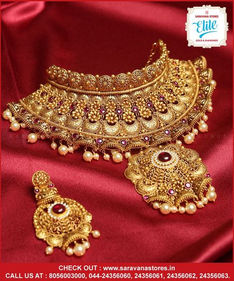 It's grandeur, festive and contemporary... this gold queenly choker is intricately designed with rubies emblished and pairs with an elegant earrings in Chandabali design. #goldchoker Check out : www.saravanastores.in Call us at : 8056003000, 044-24356060, 044-24356061, 044-24356062, 044-24356063 #goldchokerdesign #goldchokermodels #goldchokercollection #goldchokerset #Saravanaelitegold #Saravanaelite #goldpnecklace #goldnecklace #evergreen #evergreennecklace #SaravanaStoresEliteGold Heavy Gold Sets Jewelry Indian Design, Chik Set Gold, Jwellery Photoshoot Idea, Rajputana Jewellery, Nath Bridal, Heavy Jewellery, Gold Jewelry Prom, Bridal Jewellery Inspiration, Bridal Necklace Designs