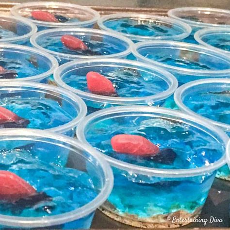 Under the sea jello shots with swedish fish. Great tasting blue jello shots made with Malibu rum. #entertainingdiva #jelloshots Rum Jello Shot Recipes, Malibu Jello Shots, Orange Jello Shots, Blue Hawaiian Jello Shots, Strawberry Margarita Jello Shots, Cherry Jello Shots, Rum Jello Shots, Pina Colada Jello Shots, Easy Jello Shots