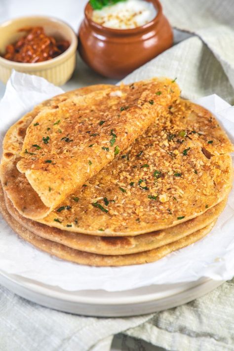 This paneer paratha is one of the popular Indian paratha recipes that is made with the stuffing of paneer, cilantro, green chilies and a few spices. These Punjabi paneer paratha makes a filling breakfast when served with yogurt, pickle or chutney. This makes a great meal when served with lentil/bean dishes like toor dal, whole masoor dal, etc. Indian Paratha, Veg Breakfast, Paneer Paratha, Bean Dishes, Toor Dal, Restaurant Style Recipes, Stuffing Ingredients, Paratha Recipe, Punjabi Food