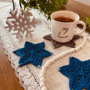 The beloved Star of David PATTERN is a festive way to celebrate the season of Hanukkah. The star-shaped design is enhanced with sparkle yarn and brightly, colored beads. Three patterns are included and enable you to create two coasters both large and medium sizes to enhance your holiday tablescape as well as a decorative ornament. Crochet Hanukkah Decorations, Christmas Crochet Coaster, Chanukah Decorations, Crochet Symbol, Invisible Join, Christmas Pillows Diy, Crochet Cushion Pattern, Crochet Terminology, Spiral Crochet