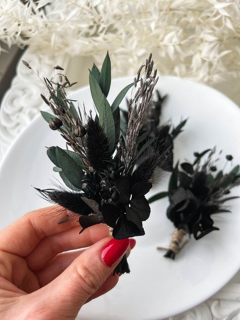 Dried flower boutonniere for Dark Moody Wedding ceremony. Dark Greenery Wedding Bouquet, Black Boutineer Ideas, Celestial Boutonniere, Moody Wedding Groomsmen, Dark Wedding Groom, Dark Moody Wedding Bouquet, Dark And Moody Wedding Arch, Gothic Wedding Boutonniere, Moody Wedding Favors