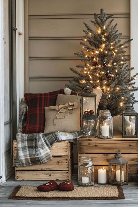 Cozy holiday porch with a lit Christmas tree, rustic wooden crates, plaid and burlap pillows, lanterns, and candles. Warm, inviting, festive atmosphere. Non Christmas Winter Decor Front Porches, Porch Light Decorations, Christmas Decor Porch Ideas, Cheap Christmas Decor Ideas, Winter Porch Ideas, Decor Porch Ideas, Christmas Decor Porch, Non Christmas Winter Decor, Diy Winter Wonderland Decorations