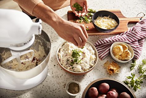 Seasoning mashed potatoes with herbs Mashed Potatoes Kitchenaid Mixer, Kitchen Aid Stand Mixer Mashed Potatoes, Stand Mixer Mashed Potatoes, White Kitchen Aid, Mash Potato Dishes, Homemade Mashed Potatoes Recipe, Kitchen Aid Mixer With Ceramic Bowl, Mashed Potatoes From Scratch, Kitchenaid Artisan Stand Mixer Colors