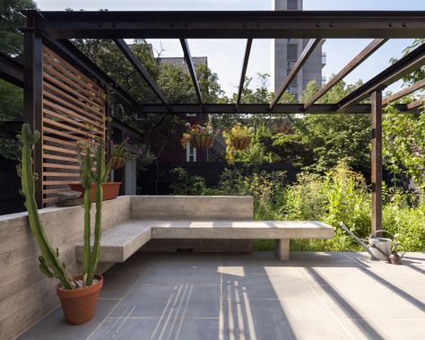 The combination of a low concrete wall and built-in bench creates an intimate seating area that acts as an extension to the kitchen and dining room. Another steel trellis above creates an armature for more plants that will fill in and provide shade. The terrace is topped with blue stone and wood screens give the plants a ladder on which to grow. Garden Seating Area, Plans Architecture, Outdoor Seating Area, Patio Wall, Patio Shade, Terrace Design, Pergola Patio, Pergola Designs, Garden Seating