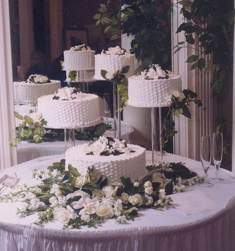 A wedding cake I made for Brian and Mari Lynn Benson.  4 separate cakes sit upon individual acrylic stands.  Cakes are covered in buttercream and a basket weave design piped onto the sides and top of the cakes.  Flowers were placed by florist. Wedding Cakes On Separate Stands, Separated Wedding Cakes, Basket Weave Wedding Cake, Table Cake Decoration Ideas, Separate Wedding Cakes, Wedding Cake Presentation, Wedding Cakes Designs, Piping Ideas, Individual Wedding Cakes