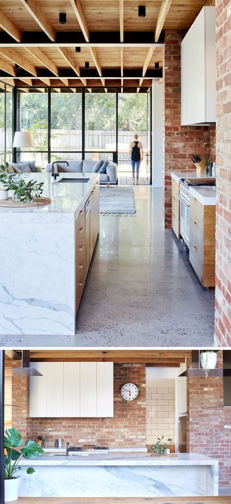 In this modern kitchen, red brick, some of which was recycled from the garden paving, covers the wall and compliments the timber paneled cabinet doors and the Statuario marble used for the countertops and island. Marble Kitchen Island, Statuario Marble, Interior Dapur, Brick Kitchen, Garden Paving, Timber Panelling, Best Kitchen Designs, Kitchen Marble, Trendy Kitchen