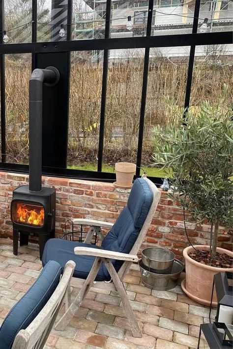 Jøtul F 105 LL black wood burning stove in a black greenhouse with brick wall. Wood Burning Stove In Greenhouse, Greenhouse Wood Stove, Wood Stove In Greenhouse, Greenhouse With Wood Stove, Wood Stove Modern, Outdoor Wood Burning Stove, Greenhouse Interior, Modern Greenhouses, Heating A Greenhouse