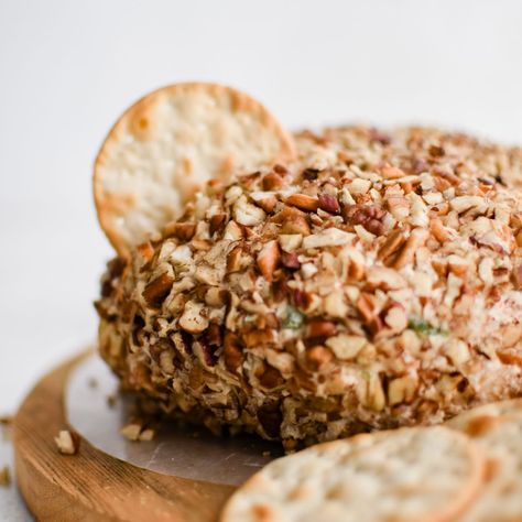 This Pineapple Cheese Ball is the retro party appetizer you've been searching for! Made with cream cheese, crushed pineapple, cheddar cheese, green bell pepper, green onions, and chopped pecans, its balance of sweet and savory flavors makes it the perfect addition to any party or gathering! Cheese Ball With Pineapple And Pecans, Cheeseball With Pineapple, Cheese Ball With Pineapple, Pineapple Cheeseball, Pineapple Cheese Ball, Pineapple Cheese, Pineapple Fluff, Pulled Chicken Tacos, Pineapple Chicken Recipes