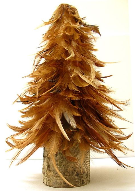 Share 	Tweet 	Pin 	Mail  Belgian artist Cathy Savel produces original art works and home decorations using natural materials such as string, paper, beans, wood and cloth–and in the case of these curious 11 inch tall trees–chicken feathers. Originally trained as … Read More... Chicken Feather Crafts Ideas, Pheasant Feather Decor, Christmas Tree Feathers, Feather Wreaths, Feather Ideas, Crafty Witch, Chicken Feathers, Diy Pallets, Feather Wreath