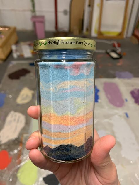 Canning the Sunset: Hundreds of Jars of Dyed Sand Preserve the Swirling Colors of a Skyline Before Dusk | Colossal Sand Jar Ideas, Sand Jars, Sand Jar, Sand Art Bottles, Sand Candles, Jar Art, Colored Sand, Grain Of Sand, Jar Diy