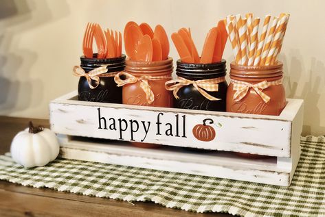 "Fall Party Decor, Painted Mason Jar Utensil Holder, Fall Kitchen Decor, Thanksgiving Table Decor, Silverware Caddy, Fun Fall Kitchen Decor How sweet is this to hold all of your silverware and straws for your next party or just your everyday dinner this Fall Season?? The box is painted and distressed and the 4 pint jars are painted pumpkin and espresso and tied with a sweet fall orange ginhham ribbon to add some rustic farmhouse charm. What a perfect little display to keep on your kitchen counte Utensil Holder Ideas For Party, Fall Party Ideas Decoration, Cheap Thanksgiving Decorations, Fall Party Decor, Mason Jar Utensil Holder, Silverware Caddy, Pumpkin Table Decorations, Decorating Hacks, Kitchen Centerpiece