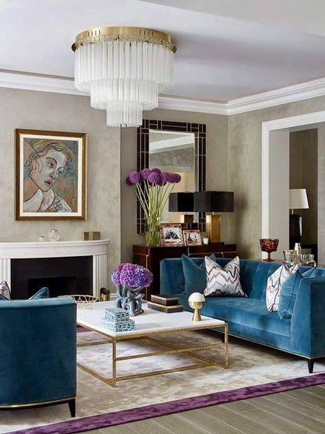 BEAUTIFUL ART DECO HOME DECOR IDEAS by Lifestyle and Home Decor Blogger Laura Lily, blue velvet couch, art deco design, tiered chandelier, art deco mirror, marble and gold coffee table, purple cream rug, art deco design, art deco inspired, geometric mirror, art deco mantel, Salon Art Deco, Teal Living Room Decor, Black Couch, Teal Living Rooms, Art Deco Living Room, Couch Decor, Room Black, Trendy Living Rooms, Room Decorations