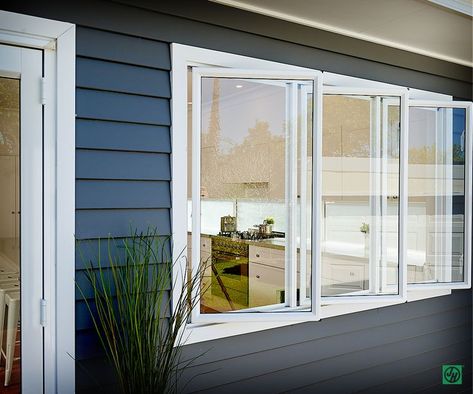 Love the bi-fold windows from the kitchen opening out to the decking area. Australia Beach House, Weatherboard House, House Paint Color Combination, Home Exterior Makeover, Upvc Windows, Exterior Makeover, Shutters Exterior, Aluminium Windows, Exterior Cladding