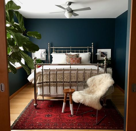 "I don't think I really have a favorite room, but I do have a soft spot for my master bedroom.  There's nothing better than reading in bed at night surrounded by those deep blue walls with lamplight glinting off the sequined Moroccan bedspread—it's like my own starry night, even when it's cloudy and raining outside." Red Carpet Bedroom Ideas, Deep Blue Walls Bedroom, Bedroom With Red Carpet, Dark Blue Bedroom Decor, Bedroom Red Carpet, Blue And Red Bedroom, Red And Blue Bedroom, Bedroom Red Rug, Red Carpet Bedroom