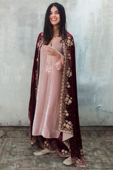 Featuring a pink kurta in velvet base with embroidery and a V-neckline. It is paired with contrasting maroon pants and a dupatta.  FIT: Fitted at bust and waist. COMPOSITION: Velvet. CARE: Dry clean only. Velvet Kurta Designs, Velvet Dresses Outfit, Velvet Suit Design, Velvet Pant, Pink Velvet Dress, Maroon Pants, Pink Kurta, Zardozi Embroidery, Velvet Dress Designs