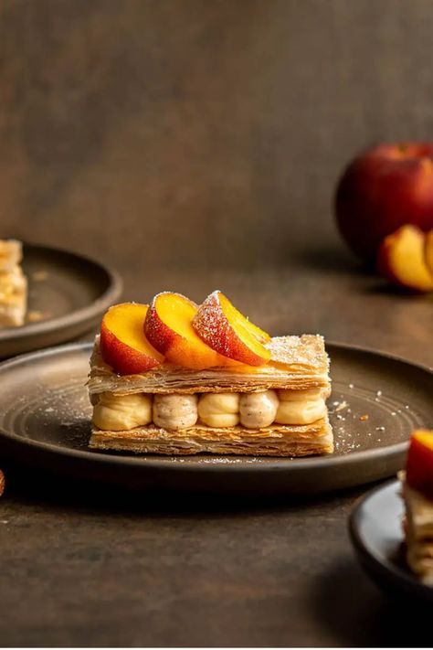 Tangy peach mousse and luscious hazelnut cream fill this peach hazelnut millefeuille. Top it with fresh peaches for an elegant look. #puffpastry #pastryrecipe #frenchpastry #dessertrecipe #peachdessert Peach Pastry, Peach Puff Pastry, Peach Mousse, Hazelnut Cream, Dessert From Scratch, Puff Pastry Filling, Easy Dessert Recipes Quick, Homemade Recipes Dessert, Peach Desserts