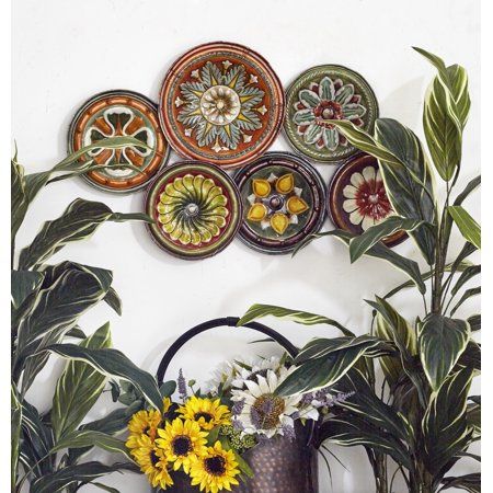 Hang an extravagant art piece of nature-inspired decoration into your rustic, artistic, and eclectic living home styles by adding this 31 inchW X 19 inchH multi-colored metal plate floral decor into your pretty walls. Intricately crafted to perfection, this flower petal metal decor showcases a stunning collection of six differently-sized, multi-colored ceramic plate montage. Their loud and bold exterior is comprised of solid iron material, offering durability and stylish functionality to any roo Succulent Landscape Design, Black Wall Decor, Plate Wall Decor, Patterned Plates, Spanish Design, Plate Wall, Plate Decor, Floral Plates, Floral Wall Decor