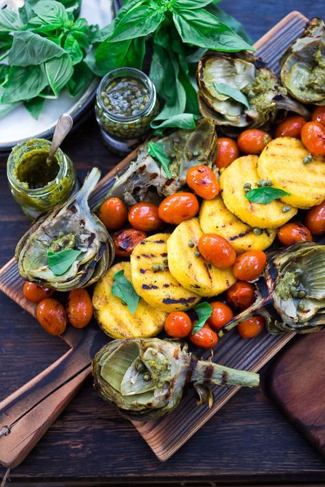 Grilled Artichoke and Polenta with blistered tomatoes, pesto, capers and fresh basil -served family style! An easy healthy rustic meal, perfect for summer nights on the patio! Vegan and GF | www.feastingathome.com| #grilledartichokes #artichokes #grilled #easy #vegan Grilled Polenta, Blistered Tomatoes, Feasting At Home, Grilled Artichoke, Rustic Recipes, Burrata Cheese, Healthy Summer Dinners, Tasty Recipe, Grilled Vegetables