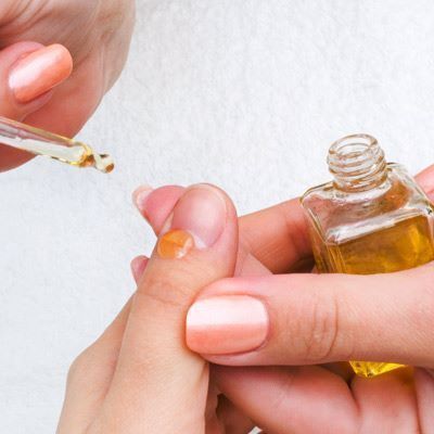 Think of your cuticles like the protective caulking around a bathtub. If you cut them back too far or push them around too aggressively, you damage them. That, in turn, leaves your nail bed open to infection. As part of regular nail care to maintain healthy nails, Kleinsmith advises moisturizing cuticles and not even pushing them back or trimming them at all, even during a professional manicure. Best Tea Tree Oil, Health Essentials, Nails Healthy, Nail Fungus Remedy, Orange Stick, Cuticle Care, Nail Oil, Nail Fungus, Strong Nails