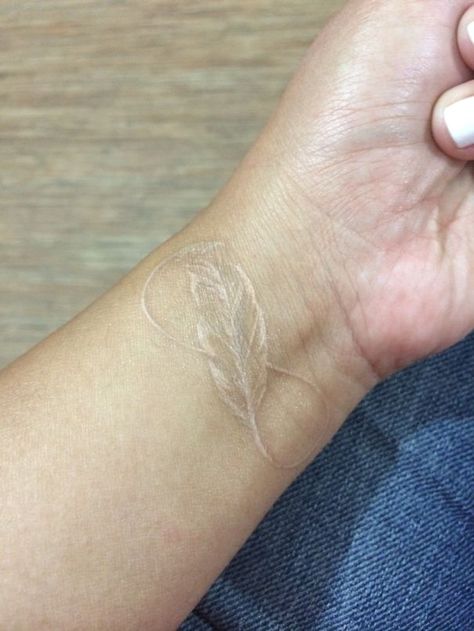 White Tattoo Of Eternity As Light As Feather Minimalist Tattoo Feather, White Feather Tattoos, Minimalist Tattoo Ideas, Literary Tattoos, Ankle Tattoo Small, White Ink Tattoo, Feather Tattoo Design, Wild Tattoo, Triangle Tattoos