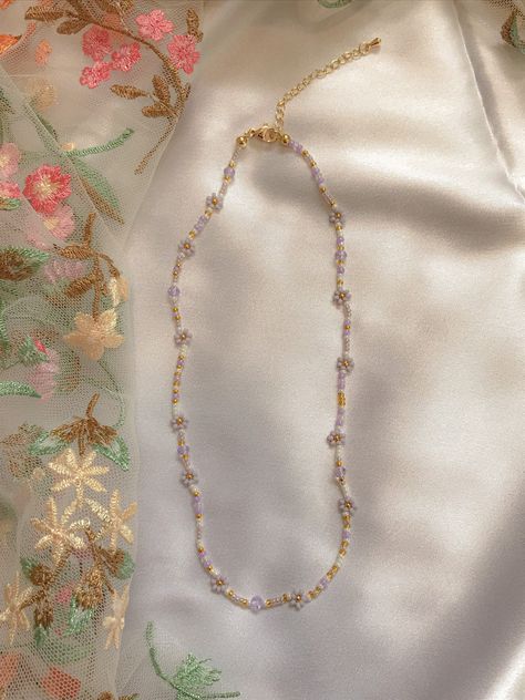 "This necklace features pearl, glossy purple, transparent gold, and 24k gold plated seed beads. It also contains clear and purple crystal beads. Length: 15\" inches Seed Bead Size: 11/0, 6/0, 4mm Adjustable: Each necklace has a 2.5\" gold filled lobster clasp extender Strung on: Non-Stretchy Beading Thread" Beaded Necklace Diy, Purple Crystals, Beaded Bracelets Diy, Lavender Flowers, Seed Bead Bracelets, Beaded Choker, Flower Necklace, Diy Necklace, Book Crafts