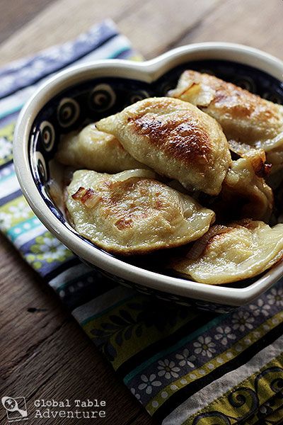 Cheese & Potato Pierogi from Global Table Adventure.  Love this site.  She is cooking food from every country around the world - one cuisine a week.  I made these Polish delicacies with my friend, Laura, and they are really good.  I like this recipe for a smaller batch.  Make EXTRA carmelized onions and add them along with sour cream to the final product!  Yum! Potato And Cheese Pierogi Recipe, Polish Meals, Pierogi Recipes, Potato Pierogi, Polish Foods, Poland Food, Lithuanian Recipes, Pierogi Recipe, Cheese Potato