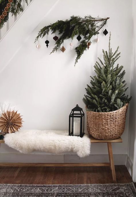 21 Scandi Christmas Decor Ideas for Your Coziest Holiday Yet Hallway Decoration Ideas, Christmas Tree In A Basket, Scandi Christmas Decor, Rustic Christmas Tree Ideas, Scandi Christmas Decorations, Christmas Hallway, Emily Henderson Design, Charlie Brown Tree, Holiday Living Room