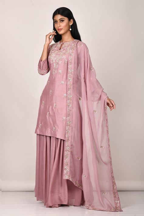 Pink embroidered kurta in gota work derail. Paired with sharara and dupatta. Component: 3 Pattern: Embroidered Type Of Work: Pearl work, Thread work, Gota work Neckline: High neck Sleeve Type: Three quarter Fabric: Dola silk, Chinnon, Organza Color: Pink  Other Details:  Keyhole neckline Sheer dupatta Occasion: Party - Aza Fashions Bandhani Lehenga, Sheer Dupatta, Kurta Sharara Set, Kurta Sharara, Pearl Work, Gota Work, Keyhole Neckline, Sharara Set, Fashion App