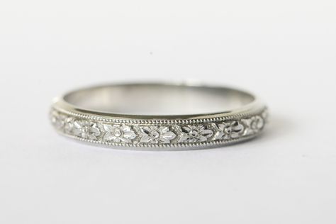 Beautiful 18k white gold engraved wedding band!  This band is wider than the typical engraved band which gives it the space needed for all the details to really show!  The center of the band has intricate flowers with a milgrain border.  There is a small band of plain white gold on either side and it gives the band such an elegant look.  Inside it has the 18k hallmark along with the lion that is Blancard & Co.'s hallmark.  They were a New York jeweler in the early to mid 20th century and made go Promise Ring Band Silver, White Gold Band Ring, Marriage Ring White Gold, Engagement Ring Engraved Band, Engraved Wedding Bands For Women, Wedding Bands For Women White Gold, Silver Wedding Bands Women, Wedding Bands For Women Silver, Vintage Wedding Rings White Gold