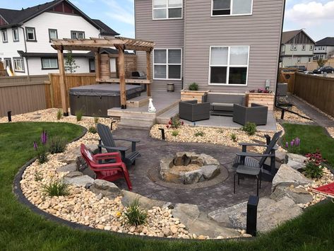 Hardscape Fire Pit Area, Backyard With Jacuzzi And Fire Pit, Low Deck Ideas Ground Level With Fire Pit, Small Yard Hardscape Ideas, Fire Pit River Rock, Side Yard Fire Pit Area, Cement Fire Pit Area, Stamped Concrete Fire Pit, Fire Circle