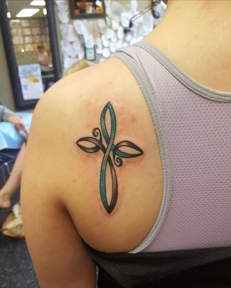 “Was diagnosed with PTSD almost a year ago. The cross symbolizes my faith in Jesus Christ, and the teal ribbon represents PTSD awareness. My tattoo reminds me Jesus is my healer and that God has great plans for me regardless of my diagnosis or what symptoms I go through. When I struggle, I notice my tattoo and remind myself of the story behind it. It’s become my personalized symbol of hope.” — Skylar T. Fire Rose Unity Survivor Tattoo, Survivor Symbol, Struggle Tattoo, Survivor Tattoos, Survival Tattoo, Survivor Tattoo, Bible Tattoos, Cross Tattoos For Women, Ankle Tattoos