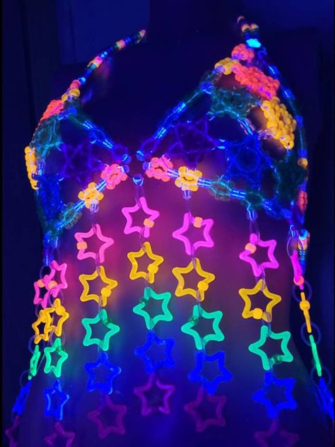 Unleash your inner star with the Glitter Star Kandi Harness! This dazzling festival outfit is a showstopper, featuring a mesmerizing kandi bra adorned with sparkling glitter stars. It’s the perfect rave clothing to elevate your style and make you shine on the dance floor. Get ready to slay in this gogo-inspired festival top! Glitter Star Kandi Harness on GlowInTheDarkStore.com Kandi Bra, Kandi Harness, Festival Kandi, Kandi Ideas, Glow Stars, Fishnet Bodysuit, Star Clothing, Rave Clothing, On The Dance Floor