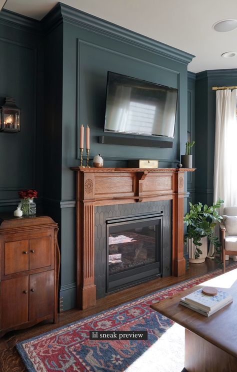 Styled Mantle With Tv, Black Fireplace Blue Wall, Dark Wood Mantle Decor, Dark Living Room Fireplace, Diy Fireplace Tv Wall Black, Vintage Mantle Decor With Tv, Adding Electric Fireplace To Living Room, Rust Fireplace, Dark Blue Fireplace