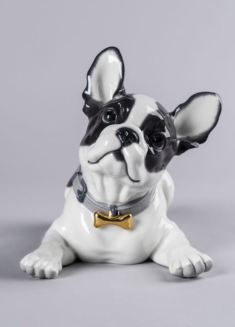 Height (in) 9.449 Width (in) 11.417 Length (in) 13.78 Porcelain Type Gloss Sculptor Raul Rubio Finished in a combination of gloss and matt, this piece is decorated with soft pastel tones, except for the intense black of the black spots of the bulldog that gives it contrast and the touch of golden brightness of the ornament worn on the necklace. Perfect for giving, collecting or decorating, made in Spain by Lladró’s expert artisans. #lladro #FrenchBulldog #bulldog #macarons #handcrafted #porcel Dog Candy, Toy Bulldog, Lladro Porcelain, Candy Collection, Lladro Figurines, Bronze Figurine, French Bull, Clay Animals, Cute Clay