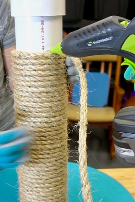 Give your cat something else to scratch on OTHER than your couch! Using a pre-cut piece of PVC, wood round, and a little rope, this can be made in a short amount of time. Gluing the rope into place with a Surebonder battery powered hot glue gun makes the process go quickly. This idea can be adapted for use in a cat condo, tower, or cat tree. Make it taller with a longer piece of PVC. Customize with carpet, felt, or upholstery material. #SBMakerFamily #catpost #pvc Diy Cat Scratching Post Easy, Pvc Cat Scratcher, Sisal Rope Cat Scratcher, How To Make A Cat Scratching Post, Scratching Post For Cats Diy, Diy Sisal Cat Scratcher, Homemade Cat Scratcher, Outdoor Cat Scratching Post, How To Redo A Cat Tower