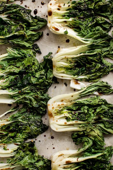 This roasted baby bok choy recipe makes a quick, easy, healthy, and delicious side dish! Garlic, lemon juice, spicy chili flakes, and soy sauce make this side dish extra tasty. Easily cooked in the oven in 10 minutes! A simple vegan recipe. Bock Choy Recipes, Vegan Side Dishes, Vegan Sides, Spicy Chili, Chili Flakes, Healthy Side Dishes, Vegetarian Recipes Healthy, Veggie Dishes, Yummy Sides