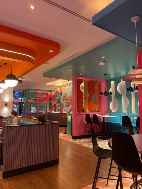 interior design of peachy keen restaurant near times square nyc. 70s vibes with bright colors Modern Retro Restaurant Design, Pop Bar Design, Colorful Commercial Interior Design, Colorful Cafe Design, Retro Coffee Shop Aesthetic, 60s Restaurant, Orange Restaurant, Industrial Coffee Shop, Fun Restaurant