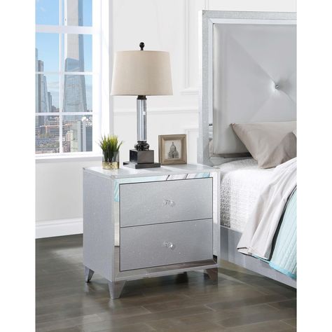 An exquisite textural effect and refined silver finish are complemented with jewel-like knobs and metallic corner braces on a modern two-drawer nightstand. Nightstand Silver, Functional Nightstand, Mirror Trim, Loveseat Living Room, Patio Dining Table, Counter Height Table, 2 Drawer Nightstand, Coaster Furniture, Wood Nightstand