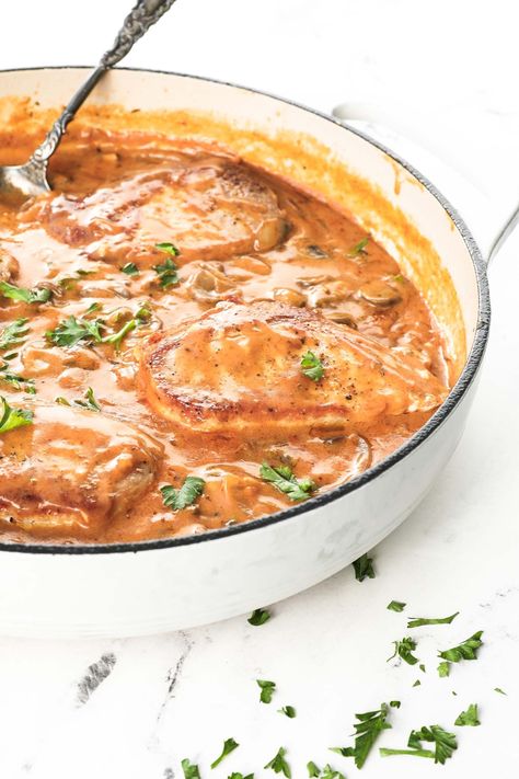 This hearty dutch oven meal is packed with flavor from juicy pork chops, onions, garlic, mushrooms and a creamy gravy. Ready in about 30-minutes in a single pan, this is a weeknight dinner winner! These easy smothered pork chops can be made gluten-free and dairy-free to fit your dietary needs. The perfect easy comfort food meal! | Real Simple Good Easy Smothered Pork Chops, Dutch Oven Pork Chops, Red Eye Gravy, Oven Pork Chops, Smothered Pork, Gravy Ingredients, Paprika Pork, Smothered Pork Chops, Juicy Pork Chops