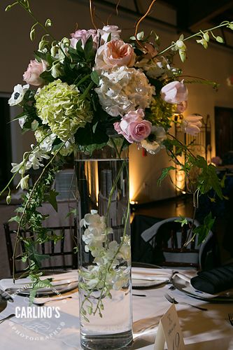 Centerpiece with 24" tall vase submerged orchids in water dressed with arrangements of green hydrangeas, juliet garden roses, blush garden roses, light pink hydrangeas, and white and black anemone.  -  Venue: Briscoe Manor, Photographer: Carlino's Photography, Floral Design: F. Dellit Designs, Lighting: DJU Productions, Catering: Behind the Bash, Planning: Event Identity, LLC Outdoor Wedding Flowers Arrangements, Black Anemone, Briscoe Manor, Submerged Flowers, Event Identity, Outdoor Wedding Flowers, Paris Theme Wedding, Orchids In Water, Black Wedding Decorations