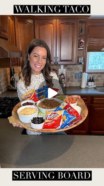 Tara Panasiuk on Instagram: "WALKING TACO BOARD 🌮❤️ So fun and delicious for entertaining and those dinner nights in 🤗 Put together your favorite taco ingredients to choose from, crush some bags of chips and put your customized ingredients inside. Enjoy! 💕 Also obsessed with this sweater! Saved in my stories and comes in a few colors 🥰 #foodboard #tacorecipe #easyrecipes #entertainingathome #recipeideas #recipeoftheday" Taco Board, Walking Taco, Company Dinner, Walking Tacos, Taco Ingredients, Chip Bags, Taco Recipes, Mexican Dishes, Appetizers For Party