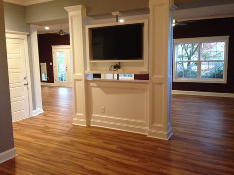 Converted two basement support beams into a TV swivel wall that separates a home gym from an open rec space. The top portion including shelf for other electronics (like a cable  box, wii, Xbox or blu Ray) allows TV sports/news viewing on one side for the home gym use, then can swivel to be viewed on the opposite side - for wii or yoga DVD uses. Pony Wall With Tv, Hiding Support Beams, Half Wall Tv Ideas, Home Gym Wall Decor, Tv Hidden, Tv Swivel, Home Gym Wall, Best Tv Wall Mount, Basement Suite