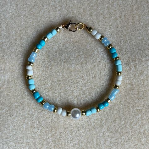 - One Of A Kind Beaded Bracelet - Featuring Light Blue, White, And Gold Seed Beads With A White Pearl Bead At The Center - Gold Colored Hardware - Clasps Closed. No Stretch. - Size/ Circumference Is 7” - Handmade (By Myself). Perfect To Treat Yourself Or To Give As A Unique Gift! **Add 2 Jewelry Items Marked “2 For $20” To Your Bundle And I Will Send You An Offer For $20** Tags: Beaded, Handmade Jewelry, Colorblock, Ocean, Pearls Check Out The “Boutique” Tab In My Closet For Handmade Earrings, B