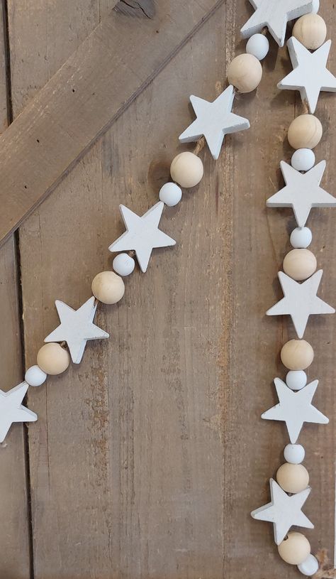 A gorgeous hand-strung wooden bead & star garland will suit any style of home decor! 72" Shipping + Returns Free 15 day return on most items. See our Shipping + Return Policy at the bottom of the page for more information Wooden Star Garland, Wood Christmas Garland, Wooden Bead Star Ornament, Wood Bead Christmas Tree, Painted Beads Wooden, Diy Wooden Decor, Diy Star Decorations, Homemade Christmas Garland, Wooden Xmas Decorations