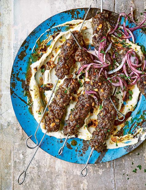 These kebabs are simple to make and cook fast on a barbecue. Rather than serve them in a wrap, make these a little different, plating them up on a slick of hummus – and then top the meat with a really zesty mix of red onion, sumac and parsley East Recipes, Beef Kebabs, Middle East Recipes, Beef Kabobs, Beef Skewers, Spiced Beef, Skewer Recipes, Mince Recipes, Beef Dinner