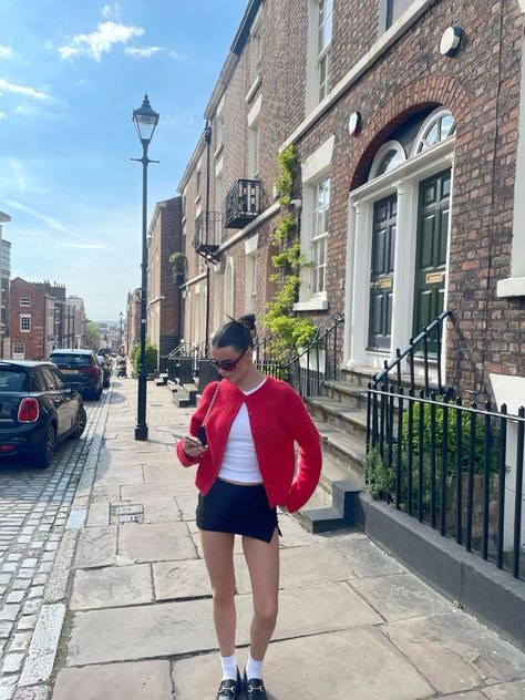 Mini Skirt Cardigan Outfit, How To Style A Red Cardigan, Little Cardigan Outfit, Pops Of Red Outfit, Loafers With Skirt Outfit, Black Mini Skirt Summer Outfit, Fashion Inspo Outfits Street Style, Styling Mini Skirts, Cardigan Outfit With Skirt