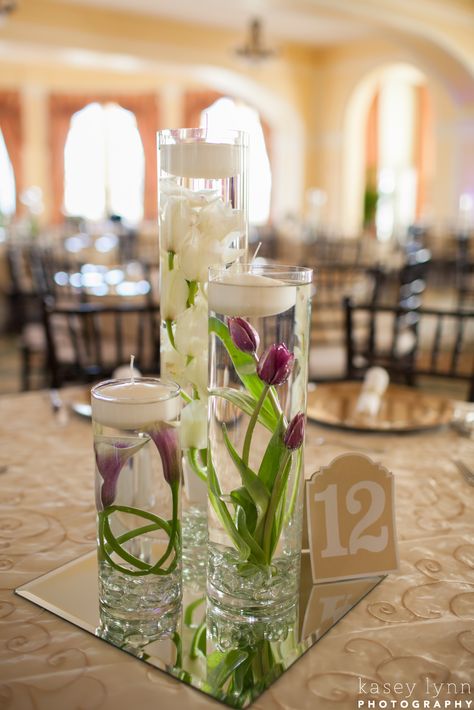 Submerged Flower Centerpieces. White Orchid, purple tulips and purple calla lilies Lily Wedding Centerpieces, Calla Lily Wedding Centerpiece, Submerged Flower Centerpiece, Calla Lily Centerpieces, Purple White Wedding, Tulip Centerpiece, Purple Wedding Decorations, Purple Calla Lilies, Calla Lily Wedding